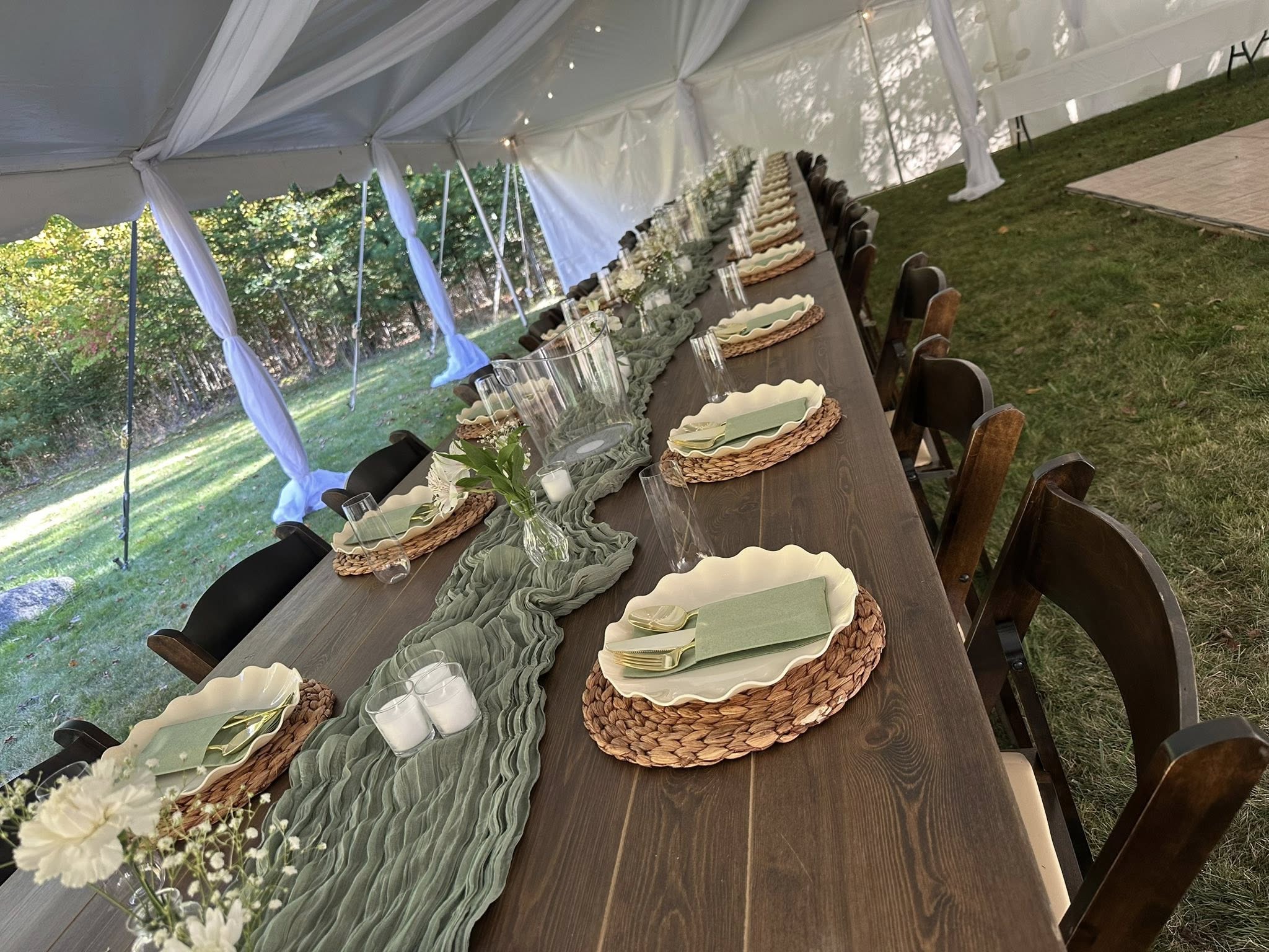 Elegantly set outdoor reception table under a white tent